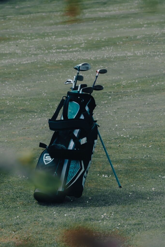 A solitary golf bag stands on a well-maintained golf course, representing leisure and sport outdoors.